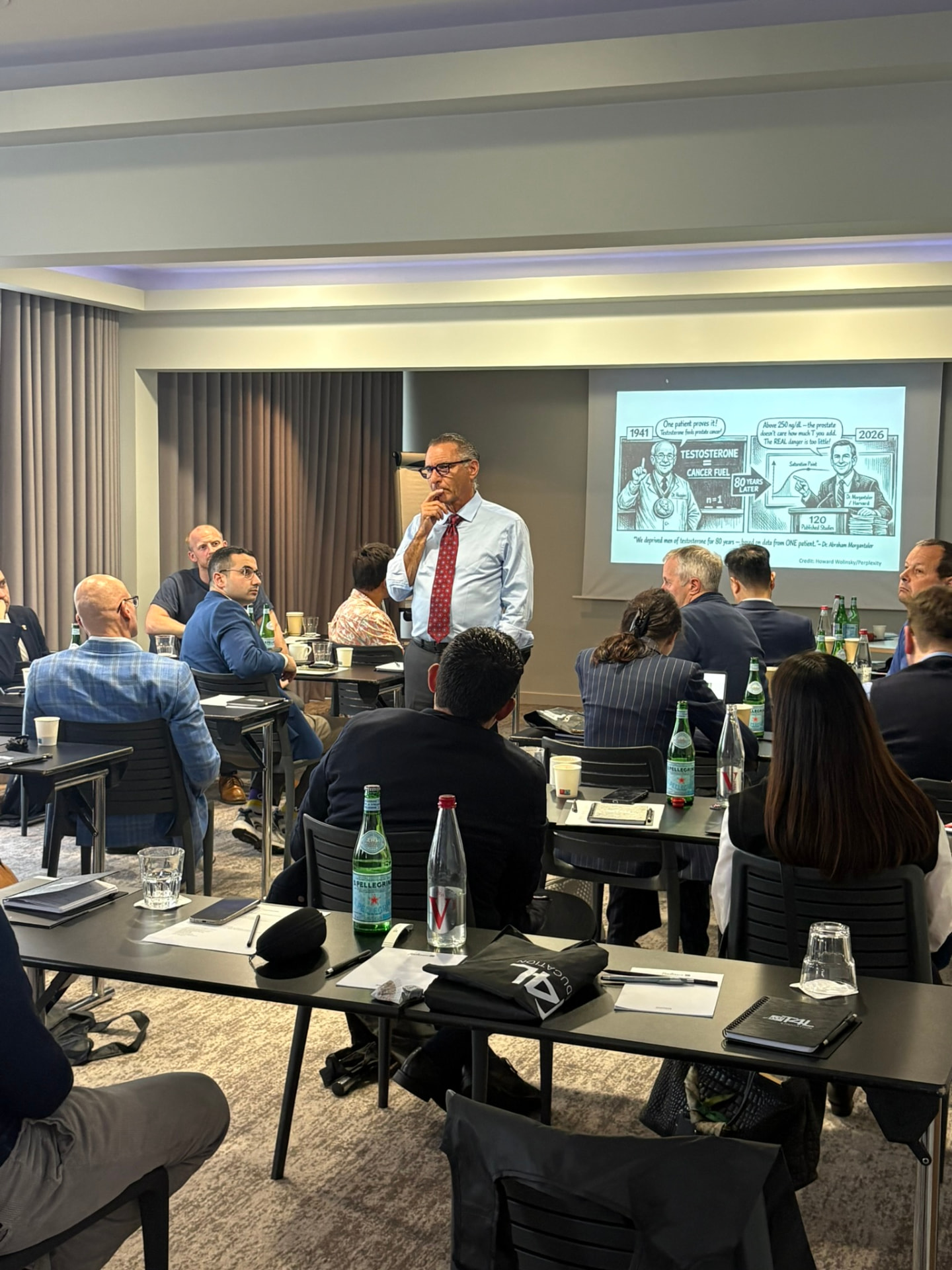 Clinicians seated around tables during a T4L Education Masterclass session