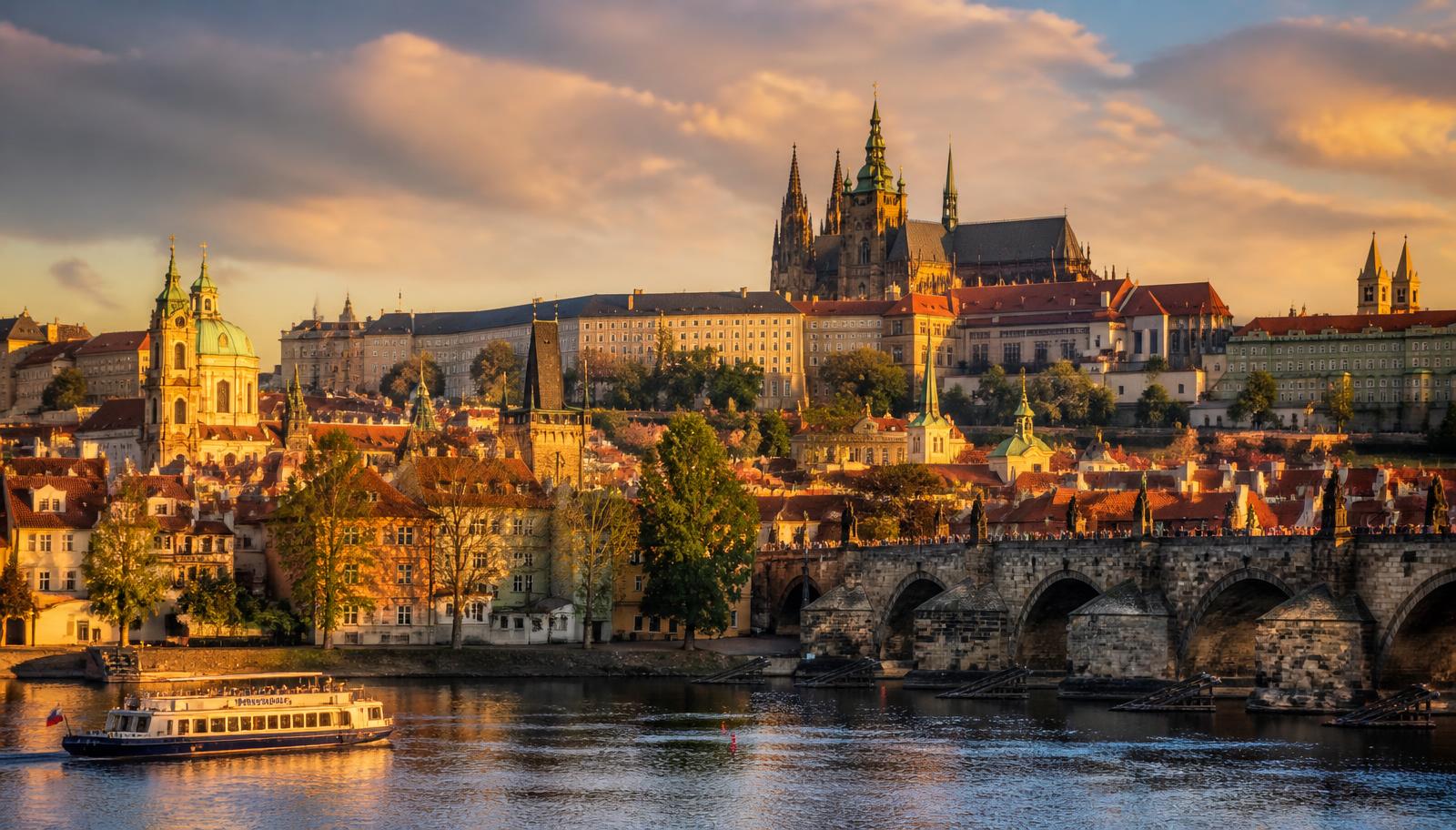 Prague Castle and Charles Bridge above the Vltava river at golden hour